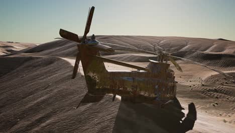 old-rusted-military-helicopter-in-the-desert-at-sunset